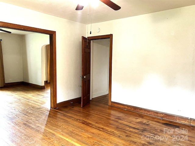 empty room featuring wood-type flooring and ceiling fan