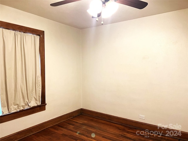 unfurnished room with ceiling fan and dark hardwood / wood-style flooring