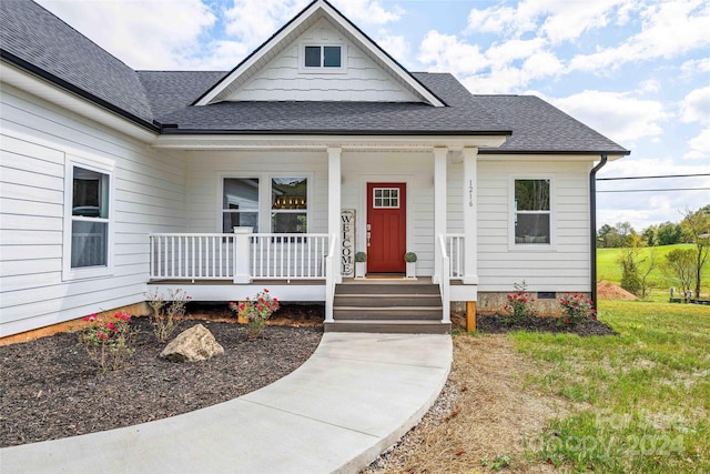 bungalow-style house with a porch and a front lawn