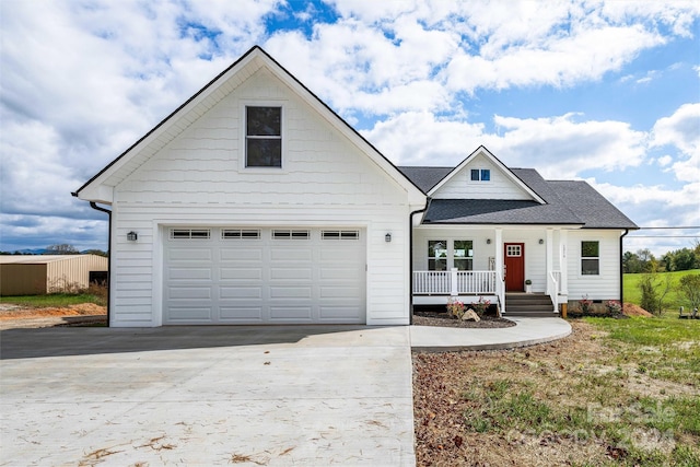 view of front of home with covered porch and a garage