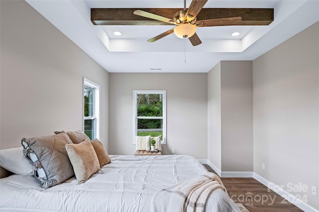 bedroom featuring ceiling fan, hardwood / wood-style flooring, and beamed ceiling