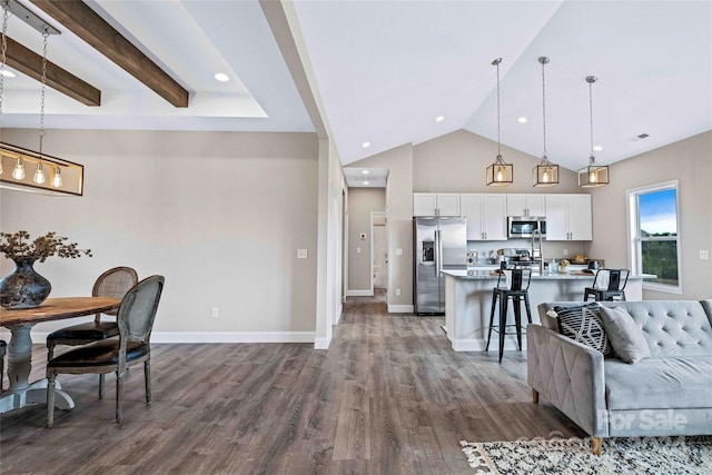 interior space featuring vaulted ceiling with beams and dark hardwood / wood-style floors