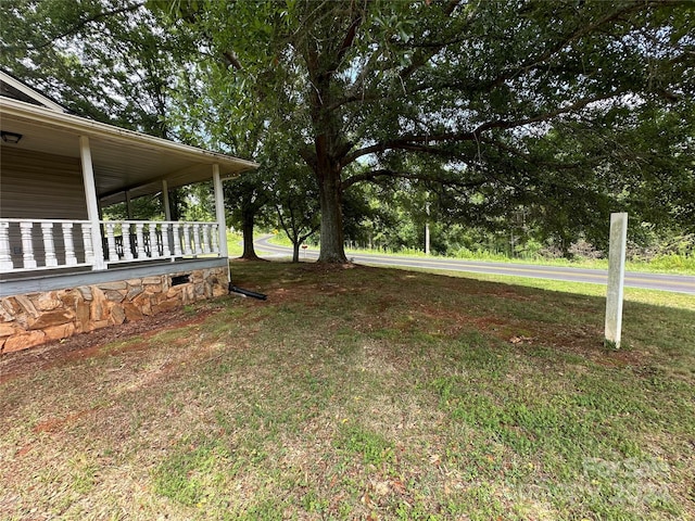 view of yard with covered porch