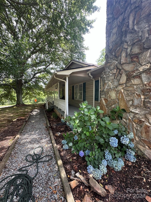 view of side of home with covered porch