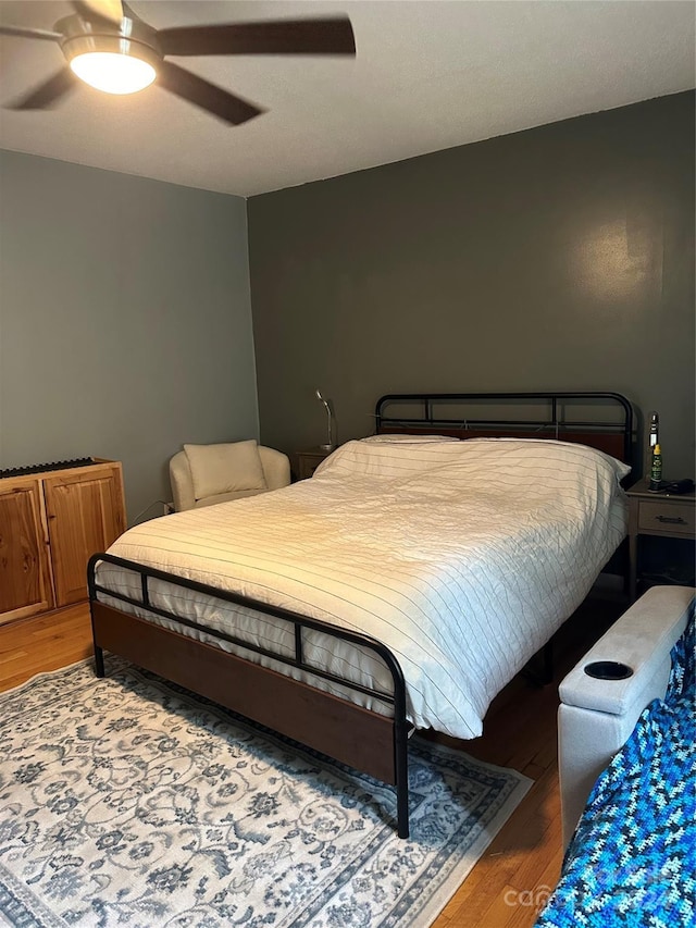 bedroom featuring ceiling fan and hardwood / wood-style flooring