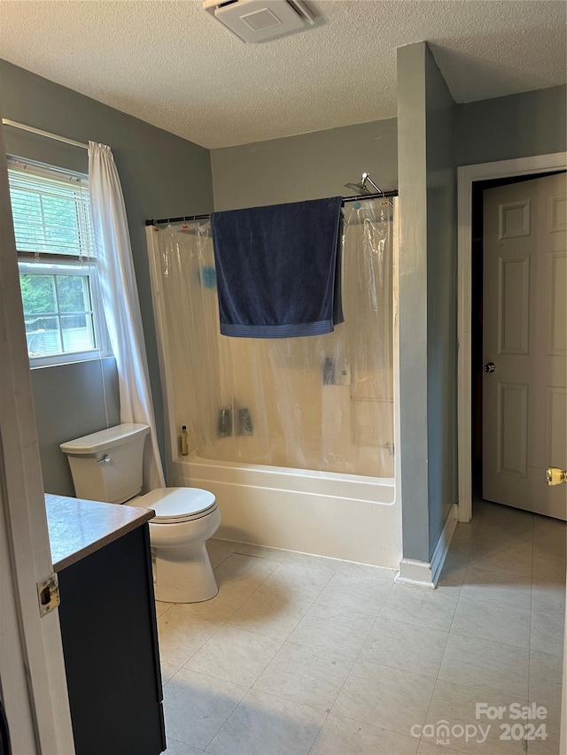 full bathroom with a textured ceiling, toilet, vanity, and shower / tub combo