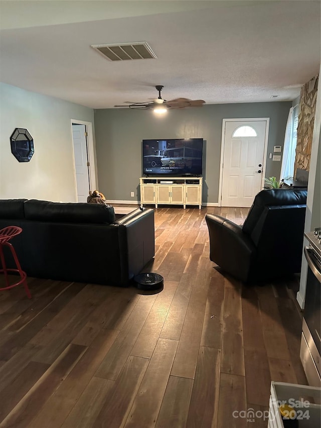 living room featuring ceiling fan and hardwood / wood-style floors