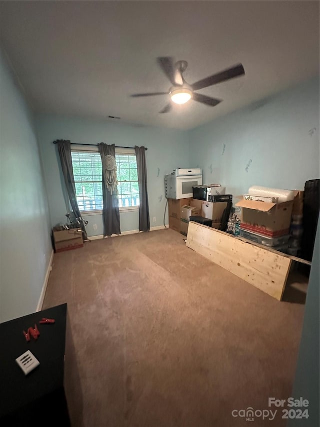 unfurnished bedroom with ceiling fan and carpet flooring