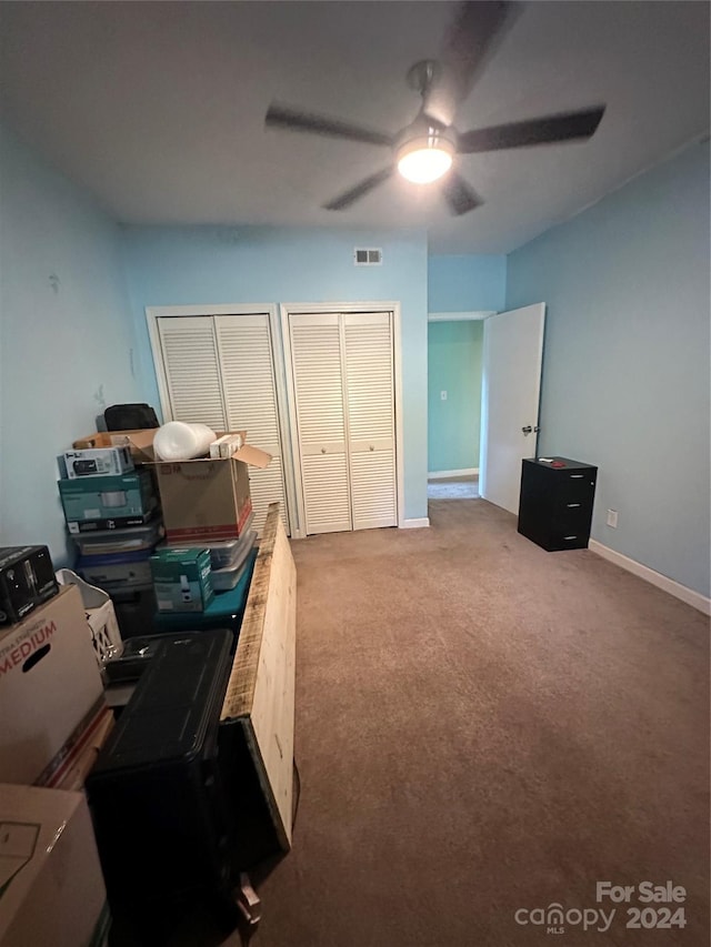 office with ceiling fan and light carpet