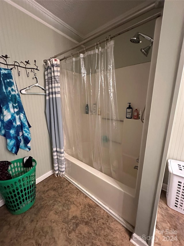 bathroom featuring a textured ceiling, ornamental molding, and shower / tub combo with curtain