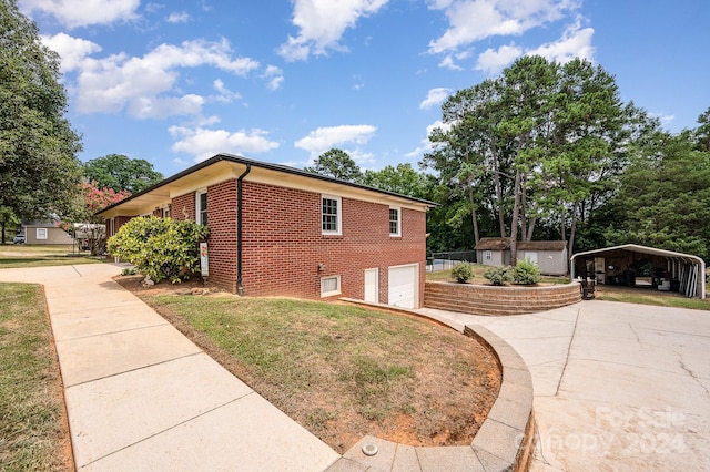 view of home's exterior featuring a lawn, a carport, and a garage