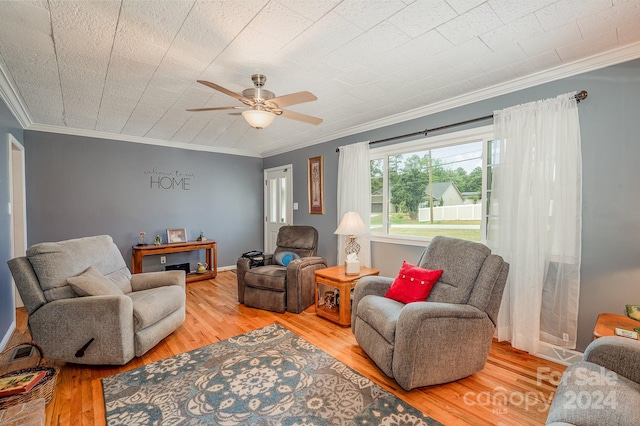 living room featuring ceiling fan, crown molding, and wood-type flooring