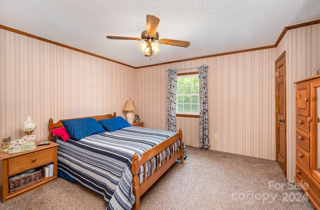 bedroom featuring a textured ceiling, ceiling fan, carpet, and crown molding