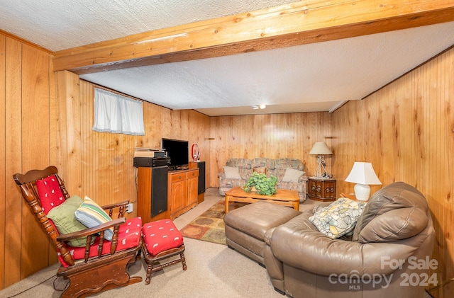 living room with light carpet, a textured ceiling, and wooden walls