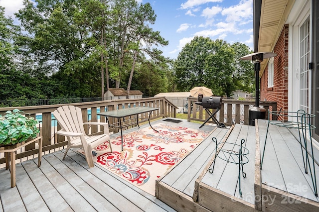 wooden deck featuring area for grilling