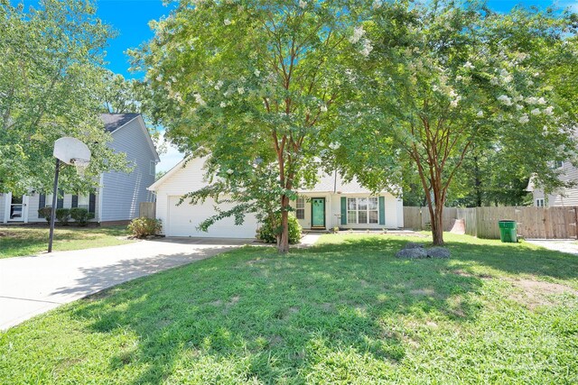 obstructed view of property with a garage and a front lawn