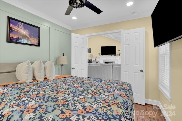 bedroom featuring ceiling fan, lofted ceiling, and hardwood / wood-style flooring