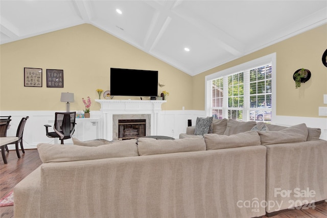 living room with a premium fireplace, ornamental molding, and hardwood / wood-style flooring