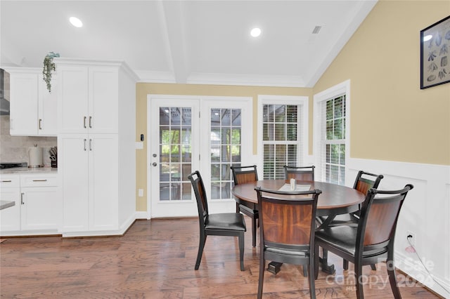 dining space featuring dark hardwood / wood-style floors and lofted ceiling with beams