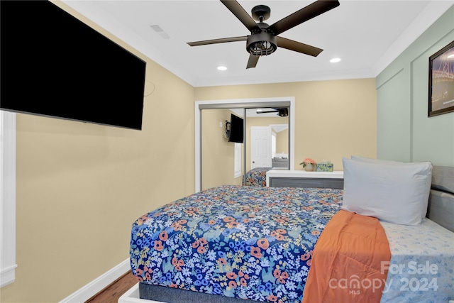 bedroom with ceiling fan, a closet, and wood-type flooring