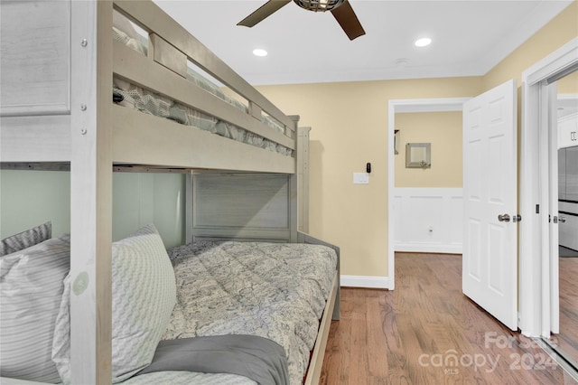 bedroom with ceiling fan and hardwood / wood-style floors