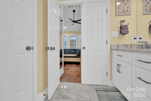 bathroom featuring ceiling fan and vanity