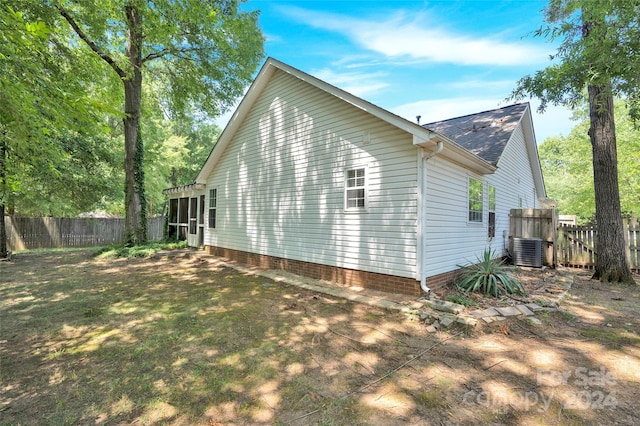 view of side of property featuring central AC unit