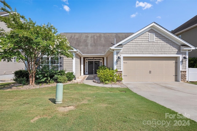 view of front of home with a front lawn and a garage