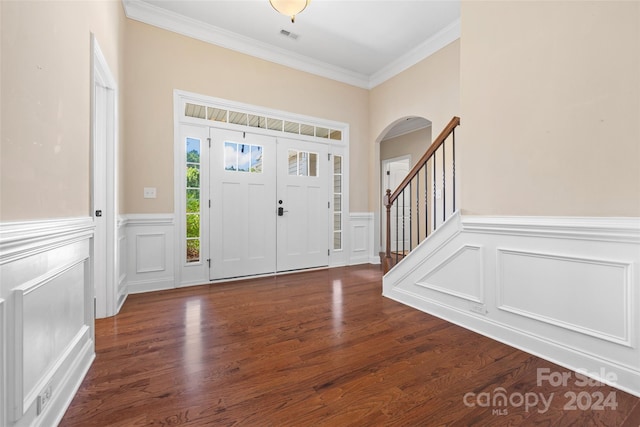 foyer entrance featuring dark hardwood / wood-style flooring and ornamental molding