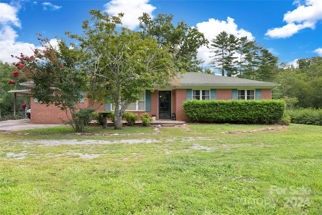 view of front facade with a front yard and a carport