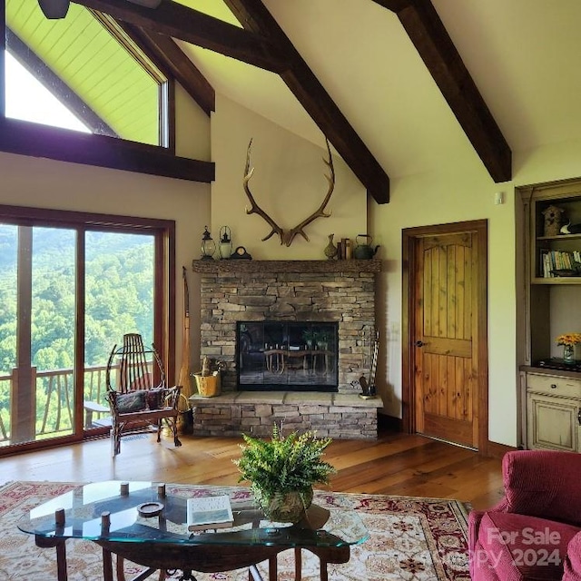 living room featuring high vaulted ceiling, beam ceiling, a stone fireplace, and hardwood / wood-style flooring