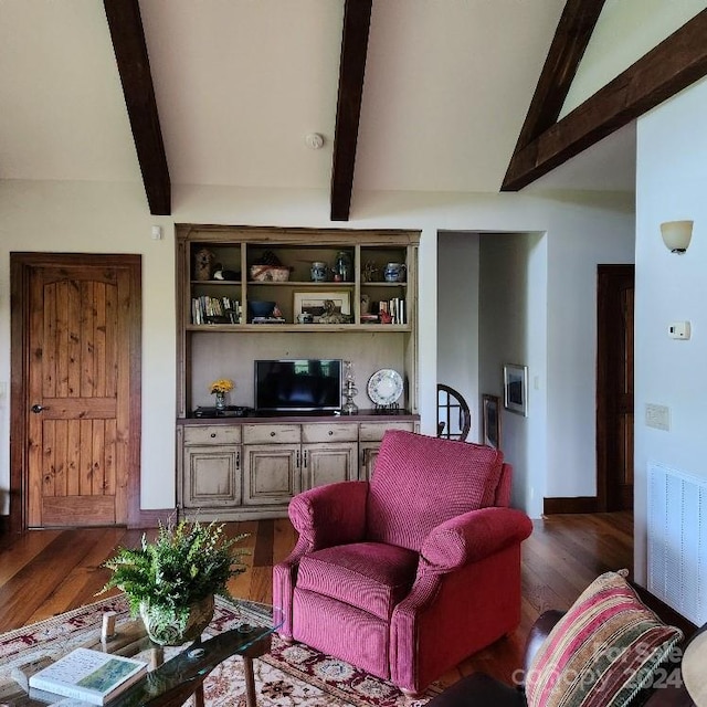 living room featuring dark wood-type flooring and lofted ceiling with beams