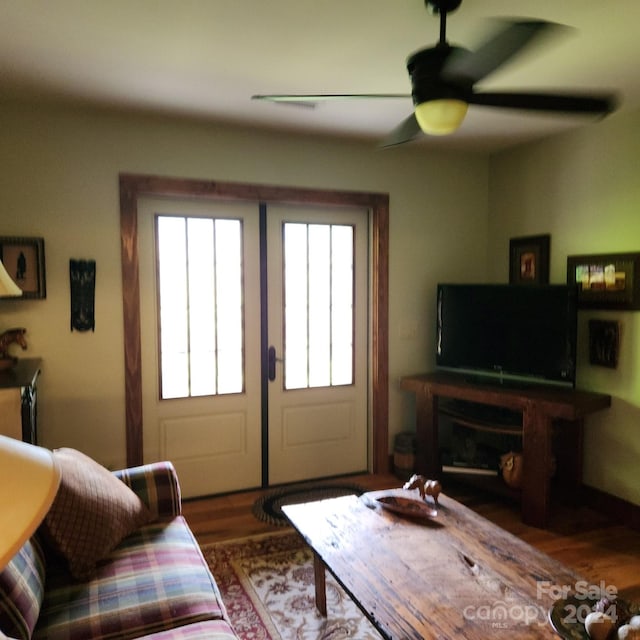 living room with ceiling fan and wood-type flooring