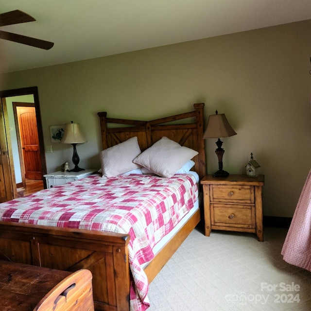 bedroom with ceiling fan and light carpet