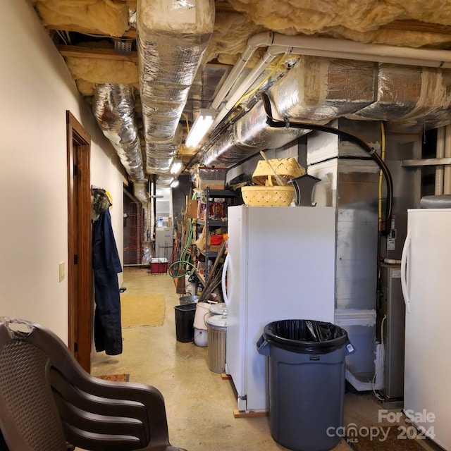 basement with white refrigerator