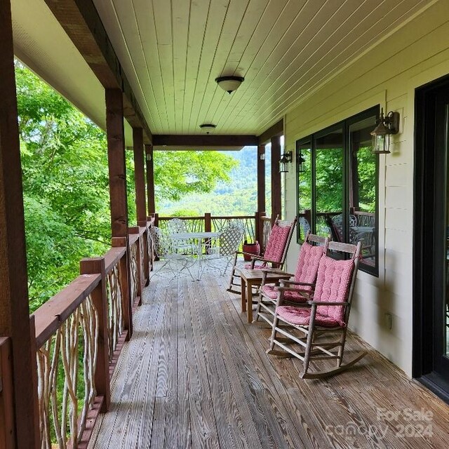 wooden terrace with a porch