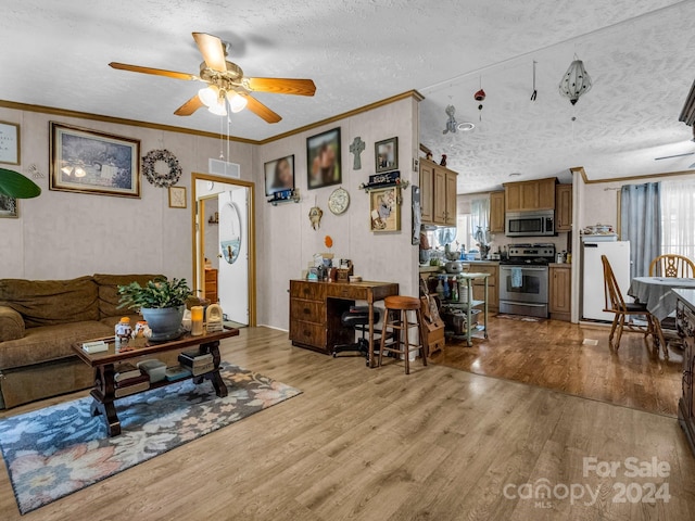 living room featuring a textured ceiling, crown molding, ceiling fan, and light hardwood / wood-style floors