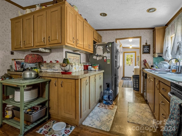 kitchen featuring a textured ceiling, ornamental molding, sink, and appliances with stainless steel finishes