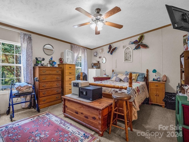 carpeted bedroom with a textured ceiling, crown molding, and ceiling fan