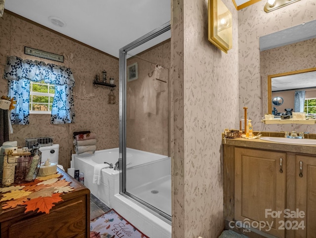 bathroom with a wealth of natural light, vanity, ornamental molding, and plus walk in shower