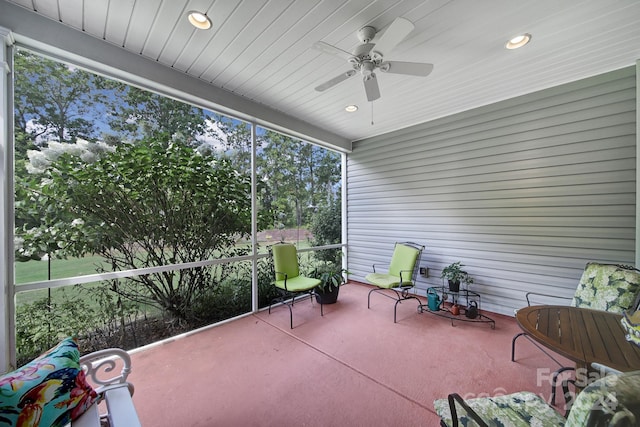 unfurnished sunroom featuring ceiling fan