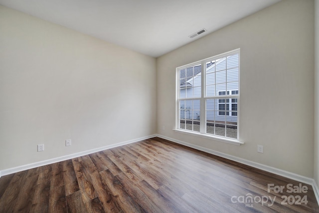 unfurnished room featuring hardwood / wood-style flooring