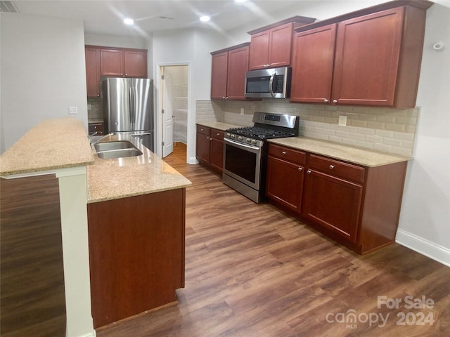 kitchen featuring decorative backsplash, dark hardwood / wood-style floors, sink, and stainless steel appliances