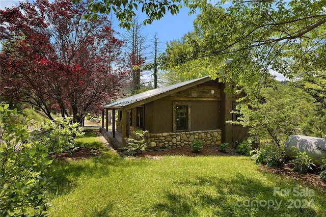 view of property exterior featuring a yard