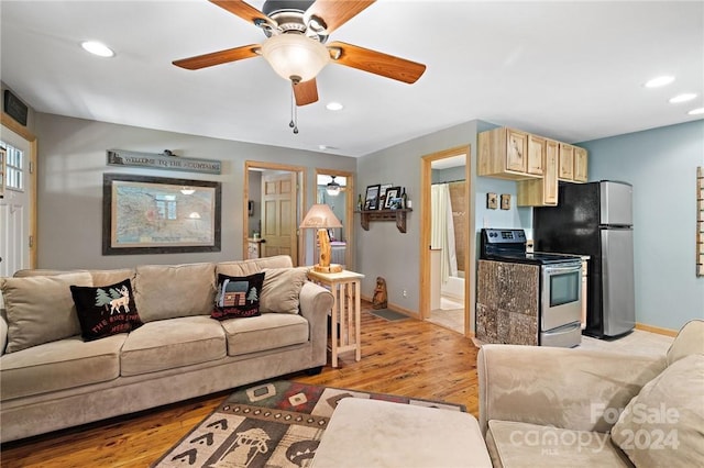 living room featuring light hardwood / wood-style floors and ceiling fan