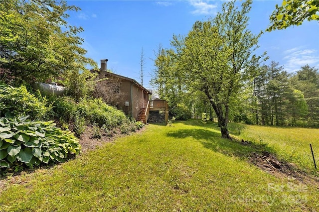 view of yard featuring a wooden deck