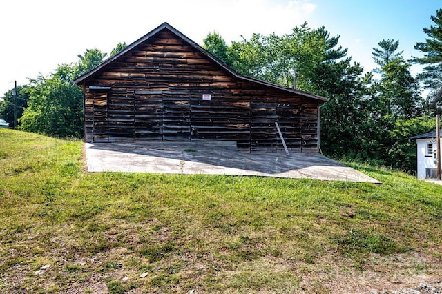 exterior space featuring a yard and an outdoor structure