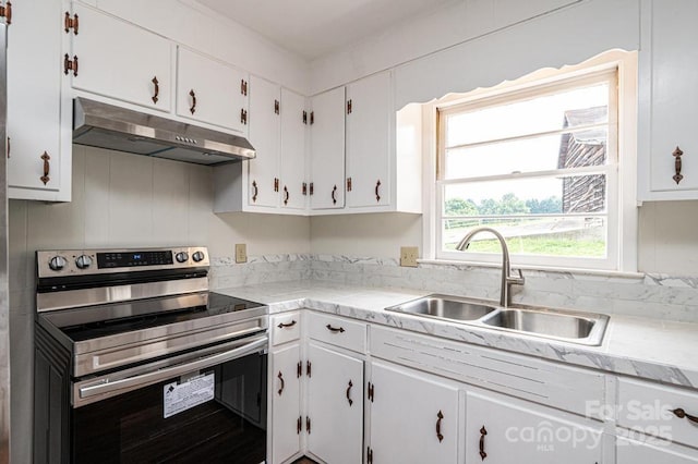 kitchen with white cabinets, stainless steel range with electric cooktop, and sink