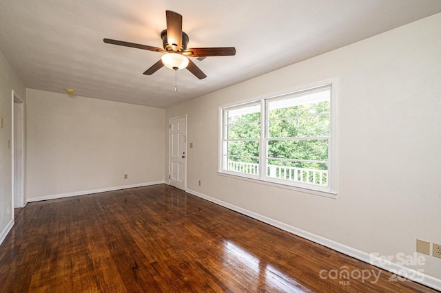 spare room with ceiling fan and dark hardwood / wood-style flooring