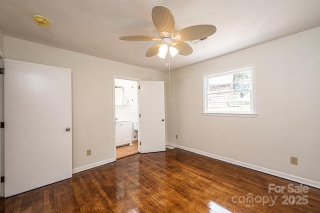 unfurnished bedroom featuring ensuite bathroom, ceiling fan, and dark hardwood / wood-style floors